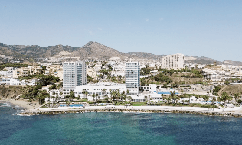 Aerial view of a Costa del Sol beachfront resort with mountains in the background in southern Spain