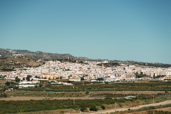 Panoramic view of a white Andalusian town surrounded by countryside under a clear blue sky