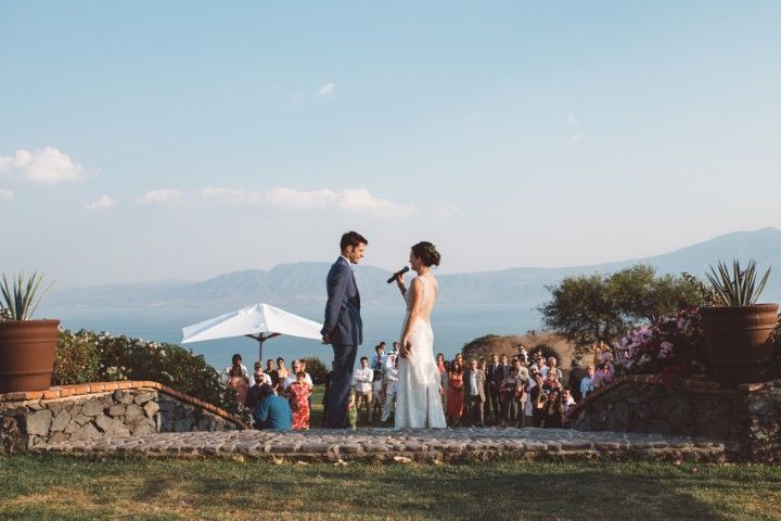 Bride walking with bridesmaids across a lawn with sea views at a wedding venue near Marbella
