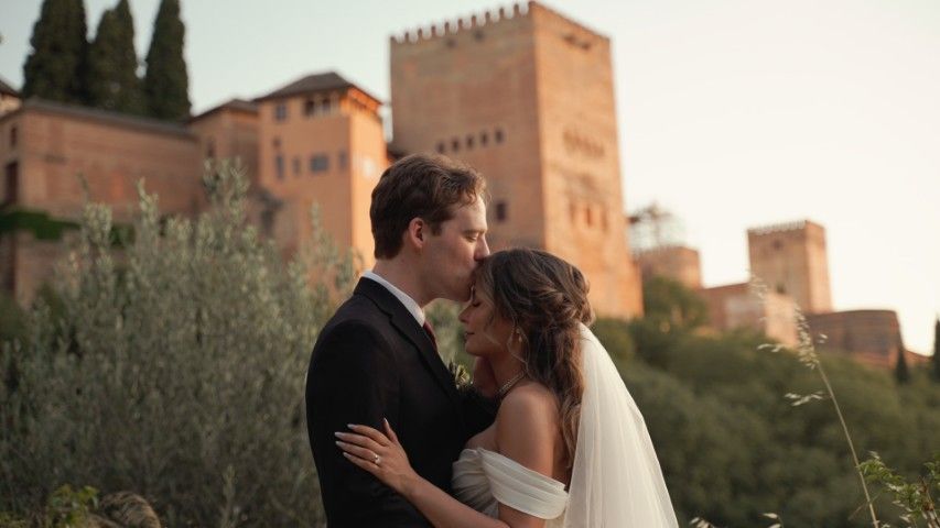 Bride and groom at Carmen de los Chapiteles in Granada with the Alhambra glowing at sunset behind them