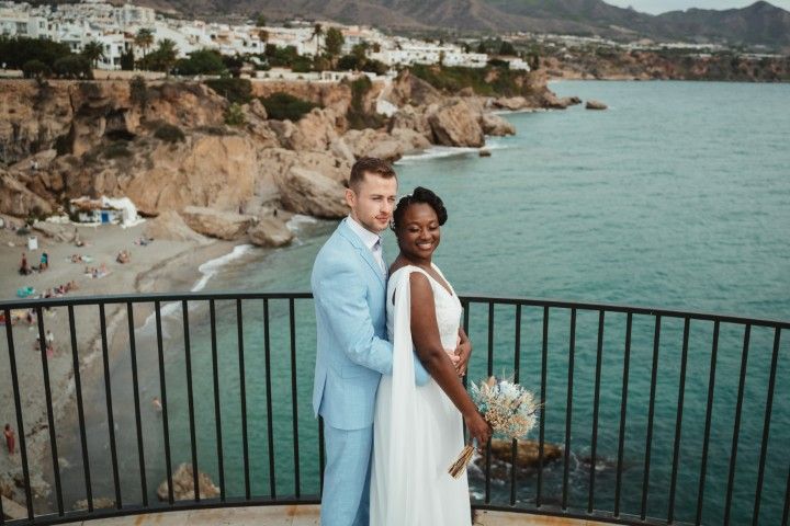 Newly married couple on a coastal viewpoint above the sea at Nerja in southern Spain