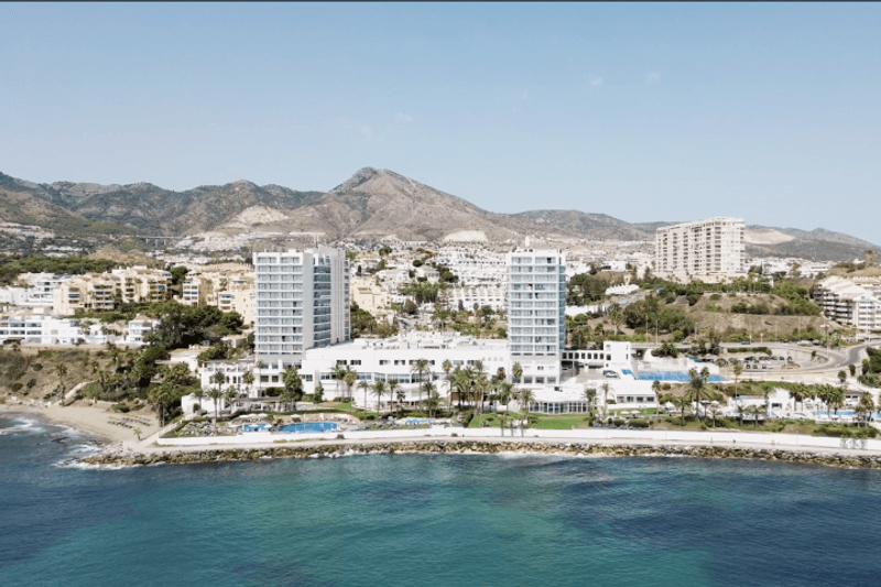 Aerial view of a Costa del Sol beachfront resort with mountains in the background in southern Spain