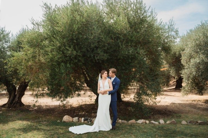 Wedding couple beneath ancient olive trees at Finca La Familia Naranja - intimate garden ceremony in the Málaga countryside
