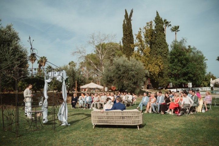 Jeffrey and Elise laughing together during their wedding ceremony at Finca La Familia Naranja, Málaga